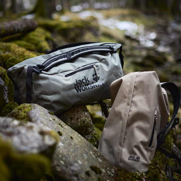 Two Traveltopia bags in the forest